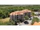 Aesthetic aerial view of complex showcasing beautiful landscaping and nearby wooded area at 1375 Tuscana Ln # 1207, Davenport, FL 33896