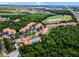 Picturesque aerial view of condo community surrounded by lush trees and featuring a luxurious resort-style pool at 1375 Tuscana Ln # 1207, Davenport, FL 33896