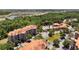 Expansive aerial view of the condo community with a pool, mature trees, and highway access at 1375 Tuscana Ln # 1207, Davenport, FL 33896
