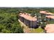 Scenic aerial showcasing multi-story building surrounded by lush greenery and landscape at 1375 Tuscana Ln # 1207, Davenport, FL 33896