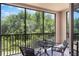 Screened balcony overlooking lush greenery, perfect for relaxing or entertaining at 1375 Tuscana Ln # 1207, Davenport, FL 33896