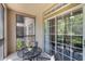 Relaxing screened-in balcony with a table and chairs, great for enjoying the outdoors at 1375 Tuscana Ln # 1207, Davenport, FL 33896