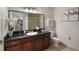 Stylish bathroom features a large mirror, granite countertop, and a glass-enclosed shower at 1375 Tuscana Ln # 1207, Davenport, FL 33896