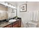 Bright bathroom featuring granite counters, modern fixtures, and a glass-enclosed shower at 1375 Tuscana Ln # 1207, Davenport, FL 33896
