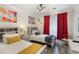 Bright bedroom showcases two twin beds, modern decor, and colorful abstract art at 1375 Tuscana Ln # 1207, Davenport, FL 33896