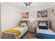 Comfortable bedroom features twin beds, stylish decor, and plenty of natural light at 1375 Tuscana Ln # 1207, Davenport, FL 33896