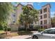 Exterior view of the condo building featuring balconies and a well-maintained landscape at 1375 Tuscana Ln # 1207, Davenport, FL 33896
