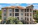 Stunning multi-story building showcasing Mediterranean architecture and lush landscaping at 1375 Tuscana Ln # 1207, Davenport, FL 33896