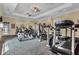 Bright gym with a variety of modern exercise machines, including treadmills, elliptical, and weight machines at 1375 Tuscana Ln # 1207, Davenport, FL 33896