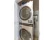 Modern, stainless steel, stackable washer and dryer combo in a dedicated closet at 1375 Tuscana Ln # 1207, Davenport, FL 33896