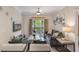 Well-lit living room with stylish decor, a balcony, and comfortable seating at 1375 Tuscana Ln # 1207, Davenport, FL 33896