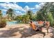 Community pool with lounge chairs, palm trees and poolside tables and chairs. Great spot for relaxation at 1375 Tuscana Ln # 1207, Davenport, FL 33896
