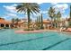 Resort-style pool featuring a sun deck, lush landscaping, and comfortable lounge chairs for relaxation at 1375 Tuscana Ln # 1207, Davenport, FL 33896