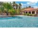 Large pool with waterfall feature, surrounded by lush landscaping and comfortable lounge chairs for relaxation at 1375 Tuscana Ln # 1207, Davenport, FL 33896
