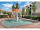 Kiddie pool with mushroom fountain water feature and lounge chairs by black metal fence at 1375 Tuscana Ln # 1207, Davenport, FL 33896