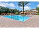 Large community pool with palm trees and lounge chairs, near the community building, great for relaxing at 1375 Tuscana Ln # 1207, Davenport, FL 33896