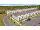 Community aerial view featuring modern townhomes, ample parking, and landscaped surroundings in a well-maintained neighborhood at 1385 Peaceful Nature Way, Clermont, FL 34714