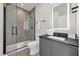 Modern bathroom featuring glass-enclosed shower and vanity with a sleek black countertop at 1385 Peaceful Nature Way, Clermont, FL 34714
