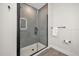 Modern bathroom features a glass-enclosed shower with gray tile at 1385 Peaceful Nature Way, Clermont, FL 34714