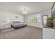 Comfortable bedroom with a large window, neutral decor, and a calming atmosphere at 1385 Peaceful Nature Way, Clermont, FL 34714