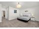 Bright bedroom with a neutral palette, featuring a comfy bed, carpeted floors, and a modern, decorative fish accent at 1385 Peaceful Nature Way, Clermont, FL 34714