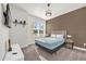 Bedroom featuring a brown accent wall, neutral walls, with a cozy bed and a sun-filled window at 1385 Peaceful Nature Way, Clermont, FL 34714