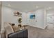 Cozy bonus room features neutral carpet, couch, and wall-mounted television at 1385 Peaceful Nature Way, Clermont, FL 34714