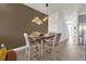Cozy dining room featuring a wooden table with seating for four and stylish decor at 1385 Peaceful Nature Way, Clermont, FL 34714
