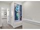 Bright hallway featuring a unique art piece and access to various rooms at 1385 Peaceful Nature Way, Clermont, FL 34714