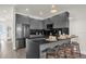 Modern kitchen features stainless steel appliances, dark cabinets, and a breakfast bar with seating at 1385 Peaceful Nature Way, Clermont, FL 34714
