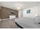 This is a primary bedroom featuring carpet floors, a brown accent wall, and a comfortable bed with soft gray linen at 1385 Peaceful Nature Way, Clermont, FL 34714