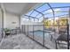 Cozy screened-in pool area with seating, offering a relaxing outdoor space in the backyard at 1385 Peaceful Nature Way, Clermont, FL 34714