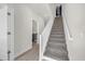 Bright stairway with carpeted steps and white banisters, leading to an upper level with neutral walls at 1385 Peaceful Nature Way, Clermont, FL 34714