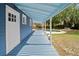 Long back porch with blue wood flooring overlooking pool and grassy area, great for entertaining at 1400 Florida Ave, St Cloud, FL 34769