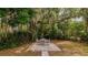 Backyard setting with a table and four chairs with a large tree providing shade at 1400 Florida Ave, St Cloud, FL 34769