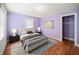 Bedroom with hardwood floors, lilac-painted walls, a chandelier, and neutral decor at 1400 Florida Ave, St Cloud, FL 34769