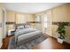 Bright bedroom with a queen bed, gray rug, and white nightstands flanked with lamps at 1400 Florida Ave, St Cloud, FL 34769