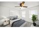 Neutral bedroom featuring a modern bed, side tables, and a green houseplant near windows at 1400 Florida Ave, St Cloud, FL 34769