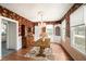 Elegant dining room with a wooden table, vintage wallpaper, and a chandelier for a classic feel at 1400 Florida Ave, St Cloud, FL 34769