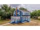 Charming two-story home featuring a blue exterior, a brick chimney, and a well-manicured front lawn at 1400 Florida Ave, St Cloud, FL 34769