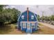 Exterior of the house with pool in the back, blue siding and a brick chimney at 1400 Florida Ave, St Cloud, FL 34769