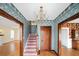 Elegant foyer featuring a staircase, chandelier, wallpaper, and wood floors at 1400 Florida Ave, St Cloud, FL 34769