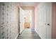 Hallway decorated with floral wallpaper that leads to a sunlit room with a fireplace at 1400 Florida Ave, St Cloud, FL 34769