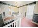 Upstairs landing with floral wallpaper, white railing, and views into adjacent rooms at 1400 Florida Ave, St Cloud, FL 34769