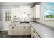 Bright kitchen featuring white cabinetry, subway tile backsplash, and gray countertop at 1400 Florida Ave, St Cloud, FL 34769