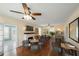 Versatile living room with fireplace, ceiling fan, and flexible layout with hardwood floors at 1400 Florida Ave, St Cloud, FL 34769