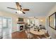 Cozy living room with fireplace, ceiling fan, and comfortable seating arrangement with hardwood floors at 1400 Florida Ave, St Cloud, FL 34769