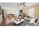Cozy living room with fireplace, ceiling fan, and comfortable seating arrangement with hardwood floors at 1400 Florida Ave, St Cloud, FL 34769