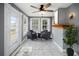 Bright sun room with large windows, tile floors, a ceiling fan, and seating, perfect for relaxation at 1400 Florida Ave, St Cloud, FL 34769