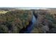 Tranquil aerial view of a calm river flowing through a lush, green forest landscape at 1532 Angler Ave, Kissimmee, FL 34746